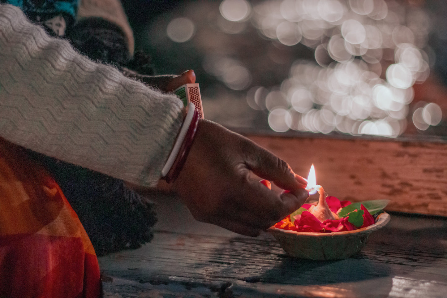 a shaman lighting a candle for the ceremony